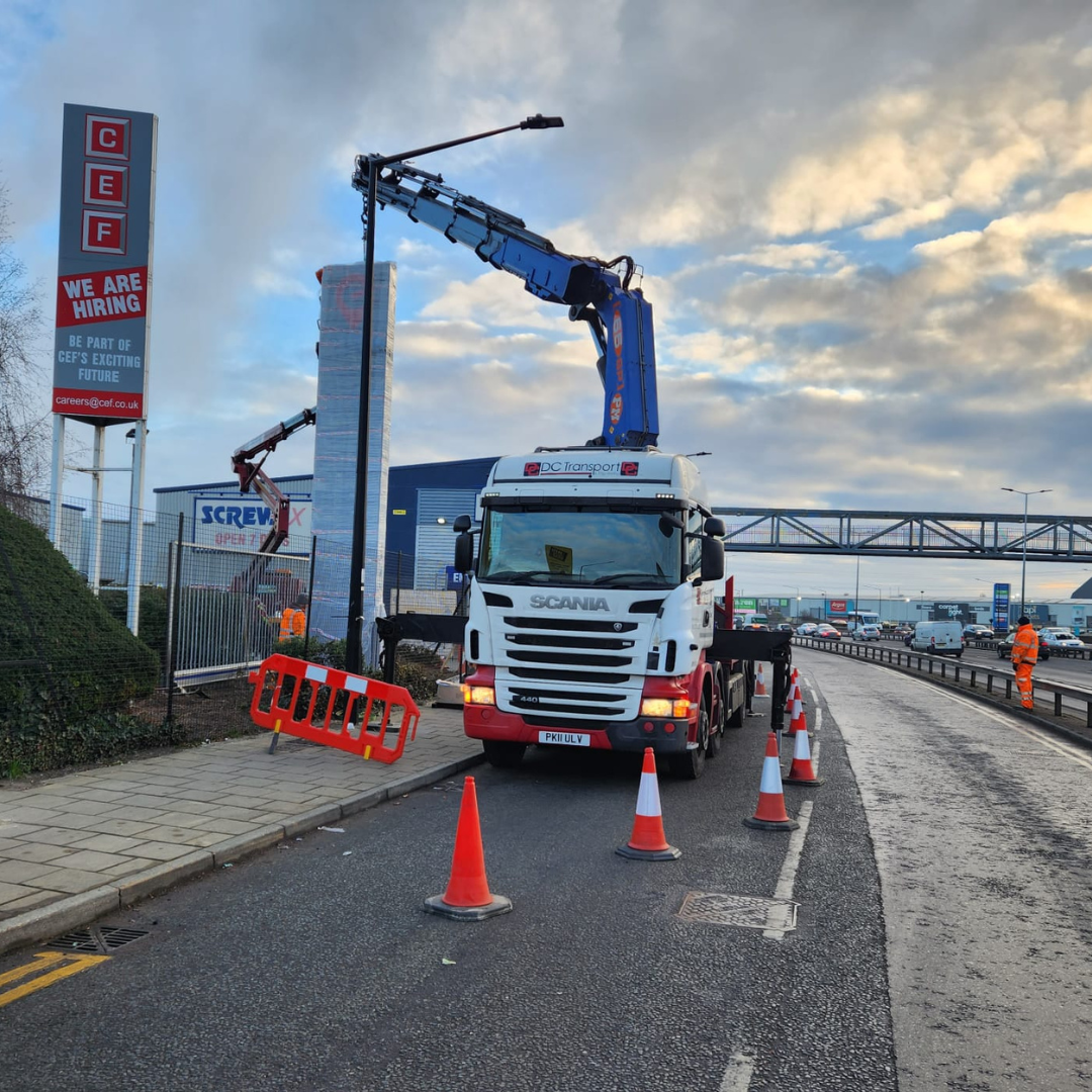 A modern Scania vehicle from the DC Transport and Engineering fleet operating on an active roadside.